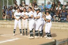 The Lady Bucks wait at home plate for Mia Castillo after her home run in the third inning Friday, April 5 against Comanche. Photo/Mike Williams