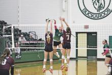 Haylie Mendoza gets a swing past a pair of Lady Bulldogs during the third set of the Lady Bucks’ 25-14, 25-23, 25-23 win Tuesday, Oct. 17 over Millsap. Photo/Mike Williams