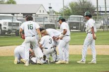 The Buckaroos celebrate a their shutout victory with a dog pile on Camden Escalon, who drove in the game-winning run Friday, April 19 against Peaster. Photos/Mike Williams