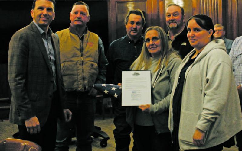 Former Stephens County Veterans Service Officer Don H. Smith was honored posthumously during the county meeting Monday, Nov. 14. Smith’s wife and daughter were in attendance to receive a flag he saluted this past Memorial Day. Photo/Stevie Watkins