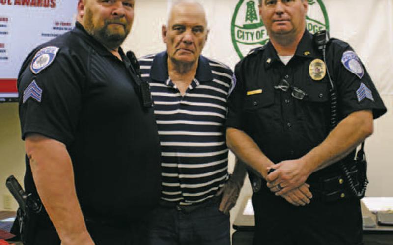 Breckenridge Police Officers Scott Gabriel, right, and Noah Gray, left, were recognized for 15 years of law enforcement service during the City Commissioners meeting Tuesday, Dec. 6. Mayor Bob Sims, center, gave the officers their 15-year pins. Photo/Stevie Watkins