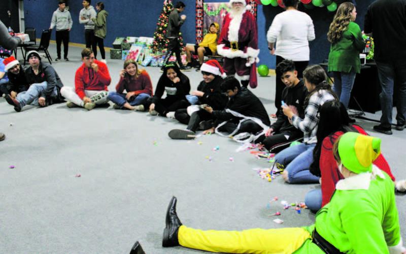 The Pride of Breckenridge Buckaroo band members gathered Monday, Dec. 19 to celebrate Christmas. Santa was in attendance and students were provided with a smoked brisket and baked potato dinner, cookie decorating kits, desserts, games, as well as a gift for each student. Photo/Stevie Watkins