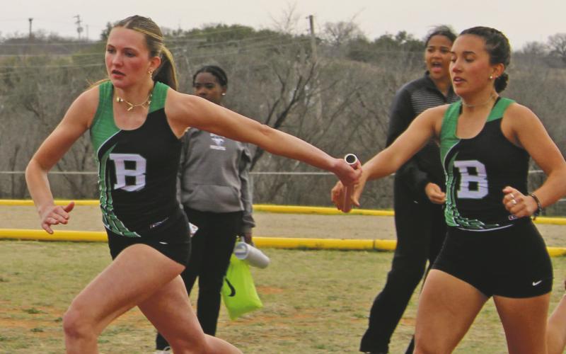Kamden Tidwell takes the baton from teammate Abbigail Duran during the 4x200-meter relay in the 2025 Buckaroos Relay. Tidwell and Duran scored top marks during the Lobo Relays held Wednesday, March 4 at Cisco High School. (Archive photo)