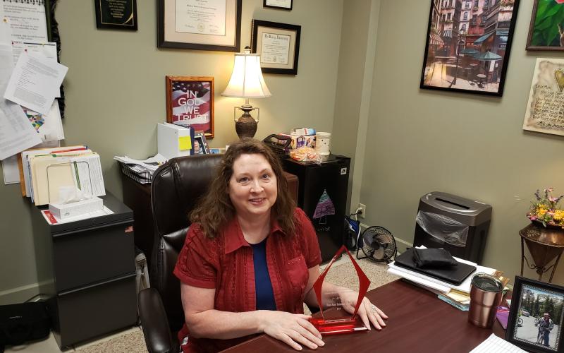 Debbie Karl sits with her award in her office. BA photo by James Norman