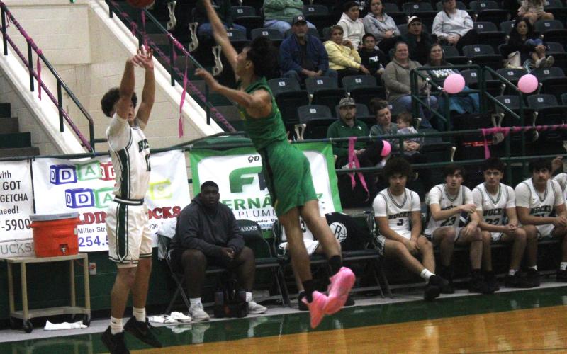 (Photo/Alex Kielar) Ryan Waller shoots a three-pointer in the corner Tuesday, Feb. 3 during the second half of the Bucks’ hard fought loss to the Dublin Lions.