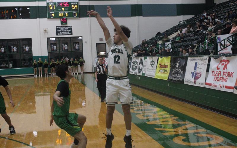(Photo/Alex Kielar) Ryan Waller shoots a three-pointer in the corner Tuesday, Feb. 3 during the fourth quarter of the Bucks’ hard fought loss to the Dublin Lions.