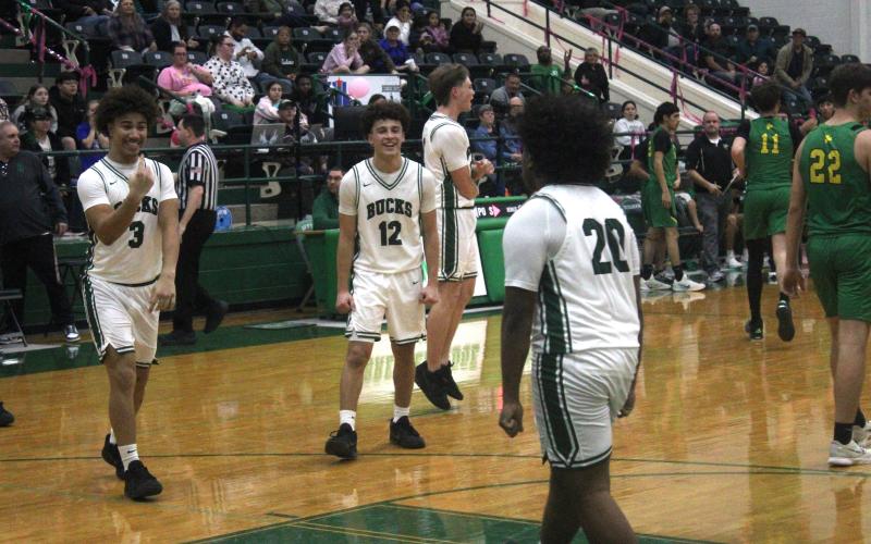 (Photo/Alex Kielar) Christian Flores (20) celebrates with his teammates Joseph Juneau (3) and Ryan Waller (12) after Flores drilled a tying three-pointer late in the fourth quarter. 