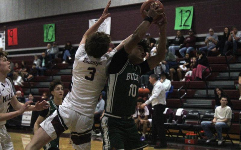 (Photo/Alex Kielar) Jaime Cruz, playing sick, fights for possession of the ball during the Bucks’ 68-49 win over the Millsap Bulldogs on the road Friday, Feb. 6. Cruz scored nine points in the win.