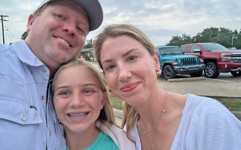 (Contributed Photo) Milly Cate McClymond reunites with her parents, Nic and Courtney, after she was rescued from Camp Mystic following devastating flooding that hit the camp July 4 weekend. 