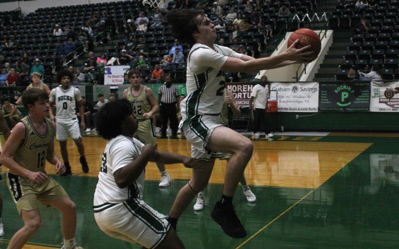 (Photo/Alex Kielar) Gavin Harrison attempts to save the ball from going out of bounds as the senior got some playing time for the Bucks on Senior Night against Comanche, as they defeated the Indians, 63-42, Friday, Feb. 13.