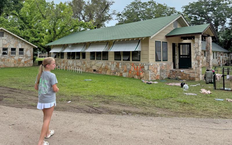 (Contributed Photo) Milly Cate McClymond looks over the devastation that was left at Camp Mystic following flooding over the July 4 weekend. 