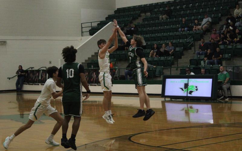 (Photo/Alex Kielar) Hudson Woodward defends a three-point shot for the Dublin Lions in the first half of the Bucks’ road 58-37 victory Friday, Jan. 9. 