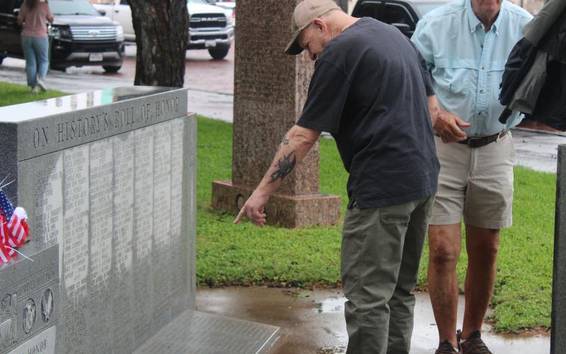 (Archive photo) A veteran points at a name on the Stephens County veterans memorial on the courthouse lawn following last year’s Memorial Day service. New names are inscribed to the monument each year and honored during the annual service which will be held this year at 10 a.m. Monday, May 25. 