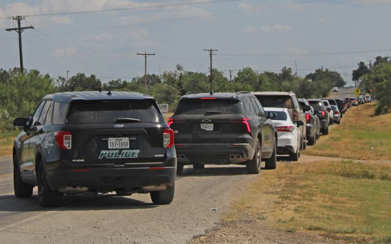 (Photo/Alex Kielar) A long line of cars out on the Industrial Loop waiting to turn west into the drive-through in front of East Elementary as Breckenridge Police enforced the new pick-up line that was implemented for the school Monday, Aug. 11. 