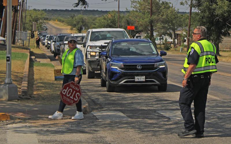 (Photo/Alex Kielar) Breckenridge Police Chief Blake Johnson helps lead the enforcement and direction of cars entering the drive-through of East Elementary off the Industrial Loop as the new pick-up plan was implemented Monday, Aug. 11. 