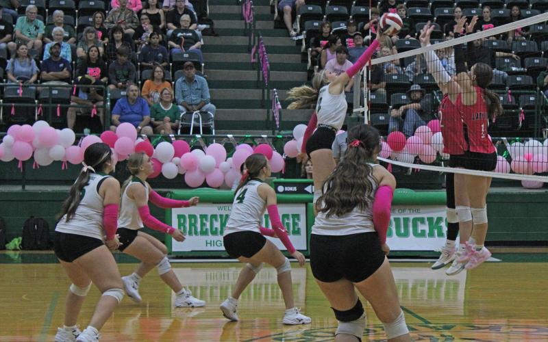 (Photo/Alex Kielar)  Lane Bartoskewitz hits the ball over the net against two Lady Lions looking to block the hit Friday, Oct. 17 during a Senior Night win. 