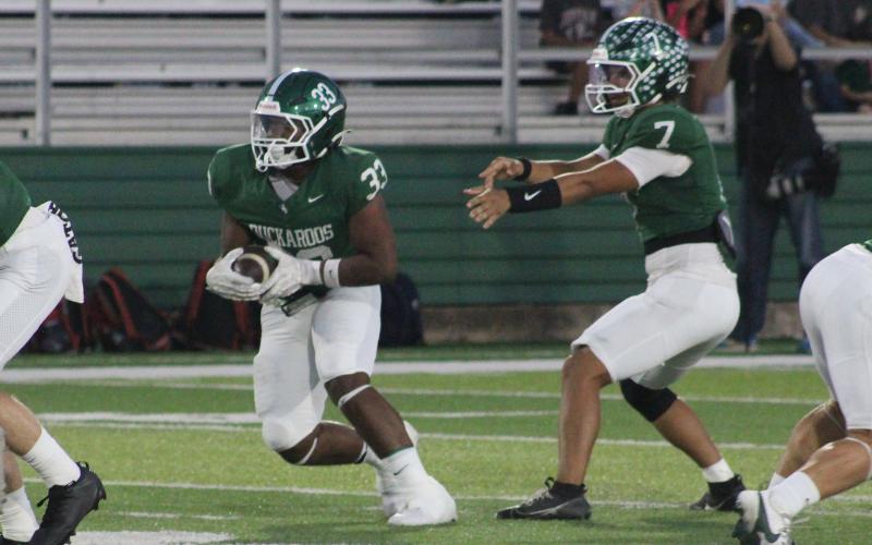 (Photo/Alex Kielar) Christian Flores runs up the middle on a handoff from Joseph Juneau during a 49-7 loss for the Bucks to Jim Ned. 
