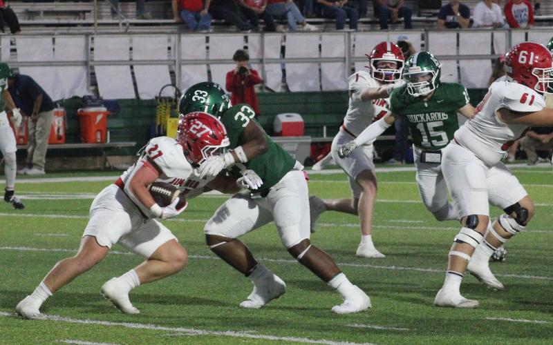(Photo/Alex Kielar) Christian Flores tackles Cole Chittum behind the line of scrimmage in the Buckaroos’ 49-7 loss to Jim Ned, in which they struggled to contain the Indians’ offense Friday, Oct. 17. 