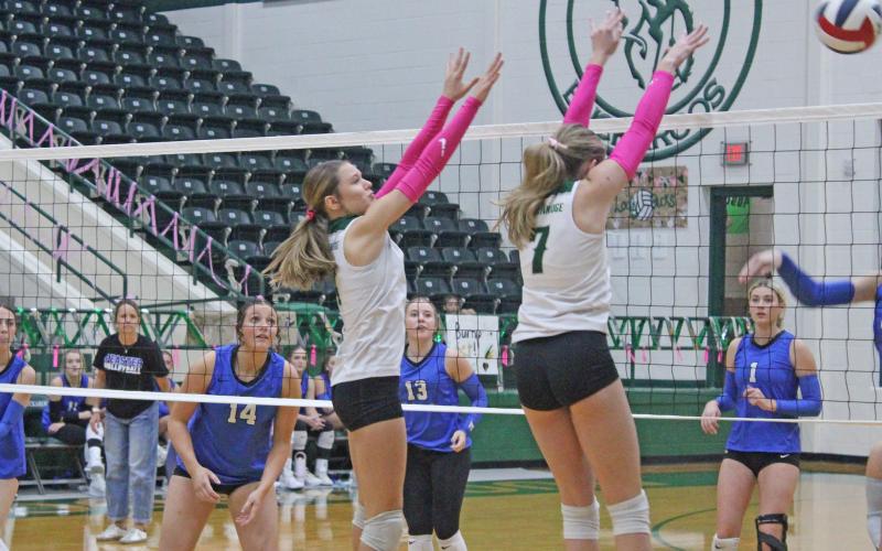 (Photo/Alex Kielar)  Kamden Tidwell, right, and LaKyla Bartley work for a block at the net against Peaster in the Lady Bucks’ final match of the season Friday, Oct. 24. 