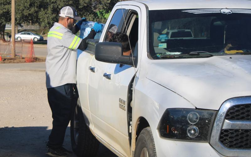 (Photo/Alex Kielar)  Volunteers and city workers helped distribute cases of water to residents who lined up at the Breckenridge City Park during the city-wide water crisis Wednesday, Dec. 10. 