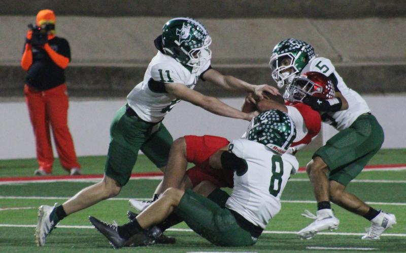 (Photo/Alex Kielar) Hunter Davis (11), Gunnar Pearce (8) and Cooper Wimberley (5) work together to get the Sweetwater ball carrier down during the Bucks’ 44-0 loss to the Mustangs Friday, Oct. 31. Davis recorded five tackles, Pearce recorded four tackles and Wimberley recorded six tackles in the game. 