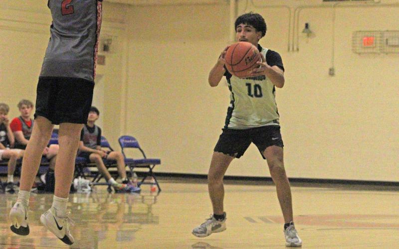 (Alex Havardansky/The Graham Leader) Kevin Araujo fakes a pass against an Olney defender Monday, Oct. 13 during the final week of the Graham fall basketball league.