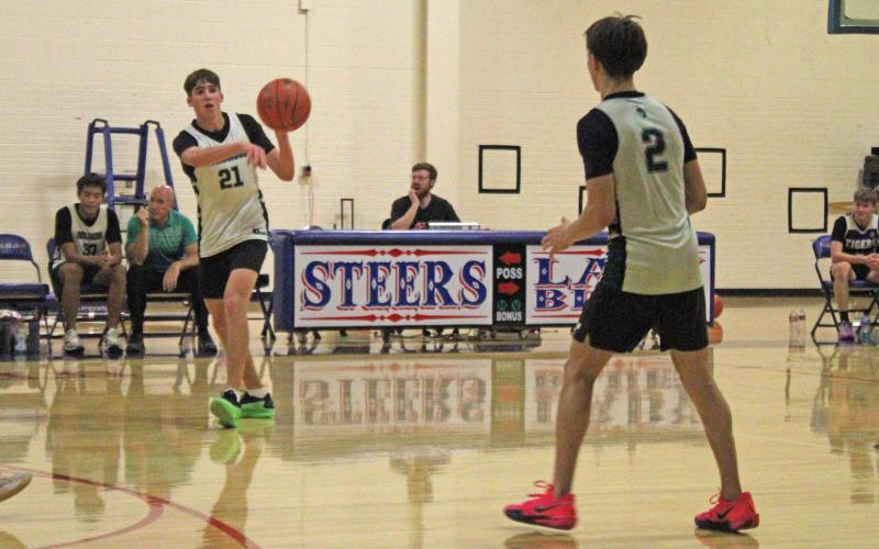 (Alex Havardansky/The Graham Leader) Bry Armstrong swings a pass to Connor Salazar at the top of the key against Jacksboro during the final week of the Graham fall basketball league Monday, Oct. 13. 