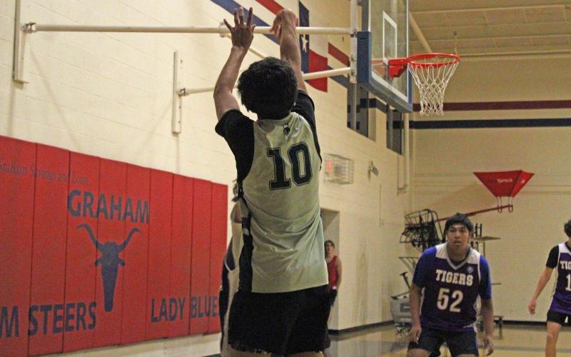 (Alex Havardansky/The Graham Leader) Kevin Araujo attempts a three-point shot from the left corner during the Bucks’ final week of the Graham fall basketball league Tuesday, Oct. 14.