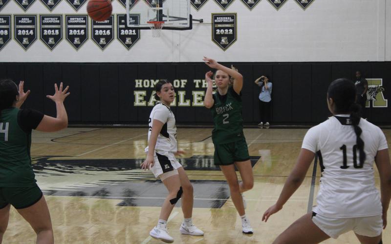 (Photo/Alex Kielar) LaKyla Bartley passes from the top of the key to Kyra Canada during the Lady Bucks win over Abilene High Saturday, Nov. 8. 