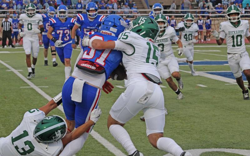 (Photo/Alex Kielar) Sophomores Tucker Baugh (15) and Ryan Waller (13) work together on dragging the Childress ball carrier down in the first half of the Bucks’ 21-14 loss to the Bobcats on the road Friday, Sept. 5. 
