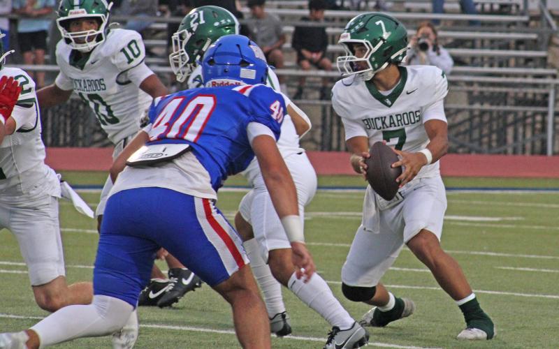 (Photo/Alex Kielar) Joseph Juneau looks to scramble after taking the snap as the Buckaroos fell short of coming up with their first win, losing 21-14 at Childress Friday, Sep. 5. The Bucks continue to roll with a three-quarterback system. 