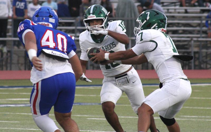 (Photo/Alex Kielar) Jaime Cruz takes the handoff from Joseph Juneau during the Bucks’ 21-14 loss Friday, Sept. 5 at Childress. 