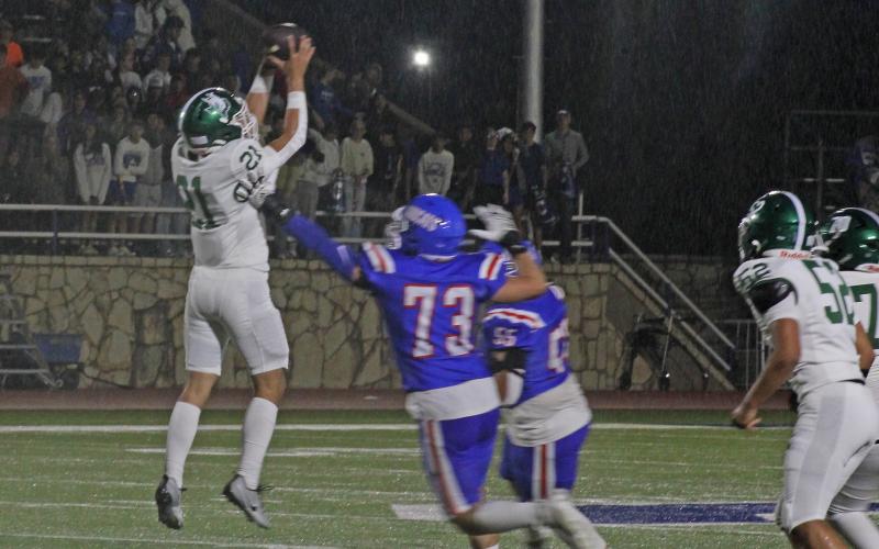 (Photo/Alex Kielar) As the rain started to fall in the first half and continued into the second half of their game against Childress, the Bucks didn’t shy away from the passing game Friday, Sept. 5. Michael Couger catches a short pass from Cooper Wimberly. 