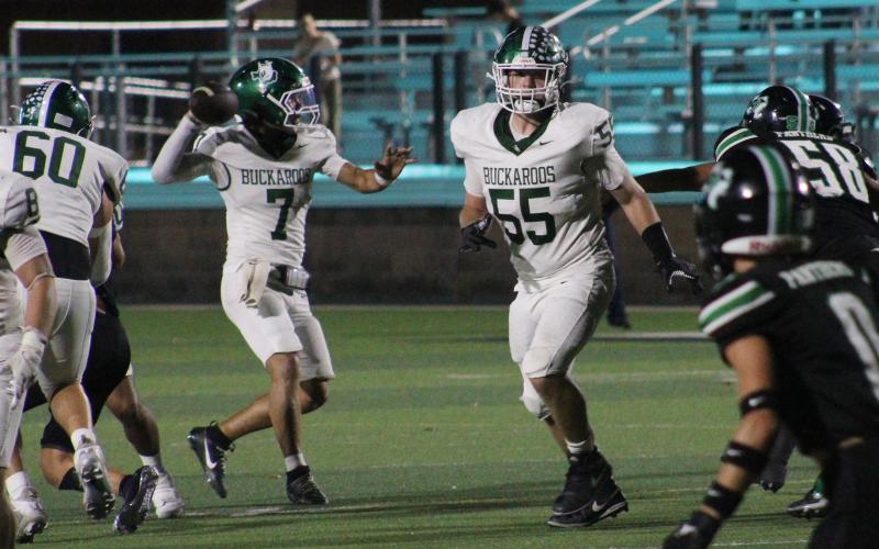 (Photo/Alex Kielar) Joseph Juneau looks to pass to his left as Brandon Niblett blocks for him during the senior pair’s final high school football game Friday, Nov. 14 at Mineral Wells Ram Stadium in a bi-district matchup against Paradise. 
