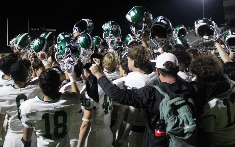 (Photo/Alex Kielar) The Buckaroos raise their helmets to close out their final huddle of the season following their 55-0 loss to the Paradise Panthers in their bi-district matchup Friday, Nov. 14. 