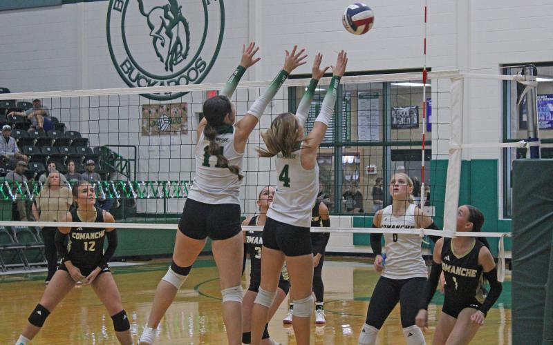 (Photo/Alex Kielar) A pair of Lady Bucks’ front line players, Paisley Thibodeux, left, and Ava Russell, work defensively at the net as they look to block a hit by Comanche during their district opener Tuesday, Sept. 9. 