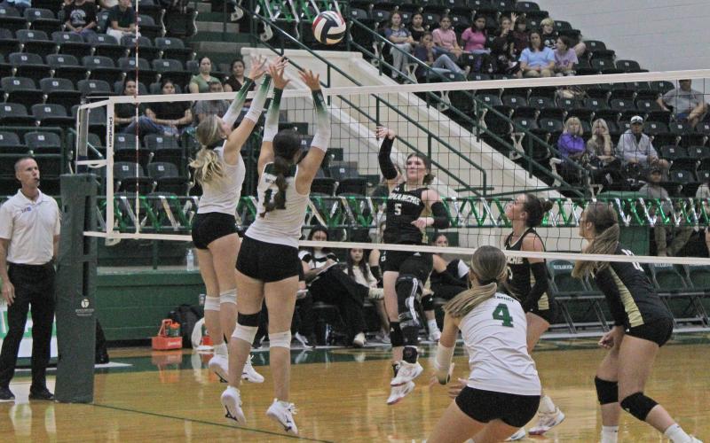 (Photo/Alex Kielar) Lane Bartoskewitz, left, and Paisley Thibodeux work to get a block at the net for the Lady Bucks during their district opener Tuesday, Sept. 9 against the Comanche Maidens. 