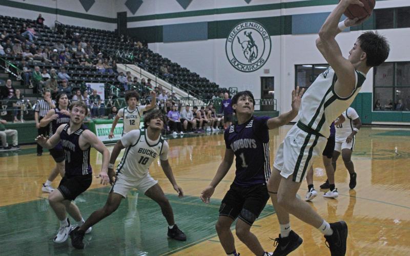 (Photo/Alex Kielar) Conor Salazar pulls up for a midrange shot attempt over a Roscoe defender Friday, Nov. 21, as the Buckaroos opened their season with a 46-42 win. 
