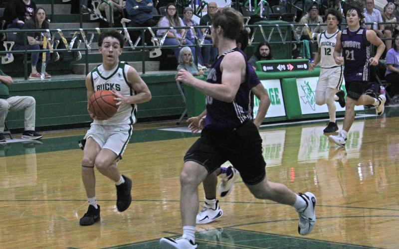 (Photo/Alex Kielar) Conor Salazar drives upcourt Friday, Nov. 21 in the Buckaroos’ season-opening 46-42 win over the Roscoe Plowboys. Salazar was the top scorer for the Bucks on the evening with 11 points. 