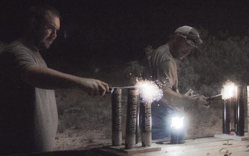 From left, Dokken Phillip and Shae Arquitte light fireworks during the Salute on the Salt Flats July 4 outside Canyon Road Barn and Grill. Show organizers aim to return bigger and better in 2018.