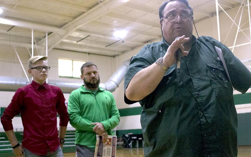 Breckenridge Junior High School student Casey Jameson and BJHS teacher Donny Funderburg look on as KEEN radio personality Rudy Fernandez talks to a crowd of BJHS students on hand for the ceremony.
