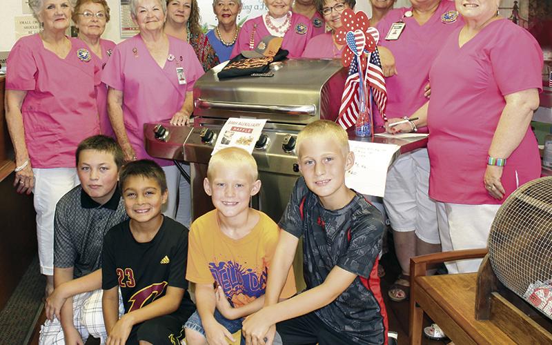 Area children and the Stephens Memorial Hospital Auxiliary pose for a photo during an event in June.