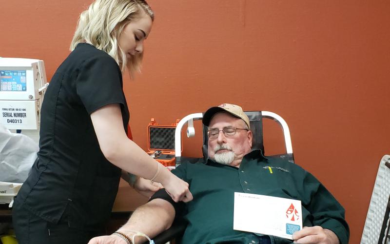 Samantha Kruse with Carter Bloodcare sets up Tom Claybrook to donate a pint of blood. Clayborn has donated at least 16 times with Carter. Kruse has worked for Carter for about two years. BA photo by James Norman
