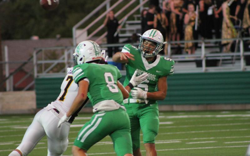 Kevin Franco throws a pass under pressure. Franco was taken out at quarterback late game and replaced by Owen Woodward. Woodward and Franco both threw one interception each. BA photo by James Norman