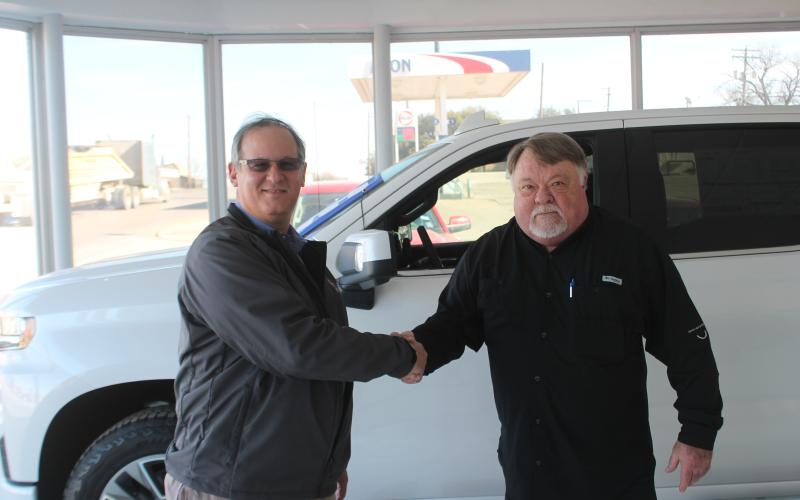 Chas Bayer and Stan Carstens shake hands to signify the deal. Carstens has had a relationship with Bayer Motor Co. for years. BA photo by James Norman
