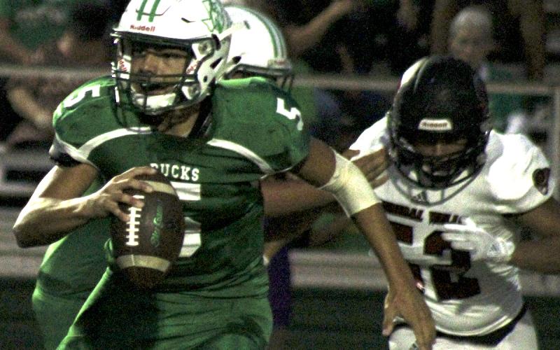 Breckenridge junior quarterback Kevin Franco scrambles away from an oncoming defender.