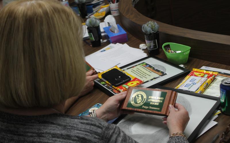 Paige Townson looks at her plaque made by BISD students in honor of School Board Appreciation Month. BA photo by James Norman