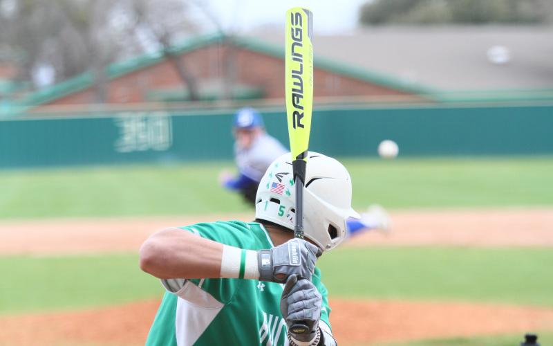 Jake Escalon (15) gets ready to swing at the ball coming across the plate. BA photo by James Norman