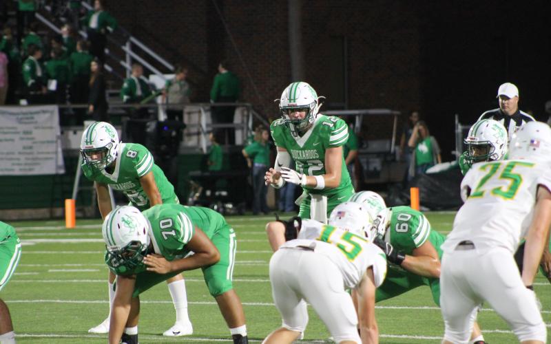 Owen Woodward prepares to take the snap. Woodward had two touchdowns in the game and two interceptions. BA photo by James Norman
