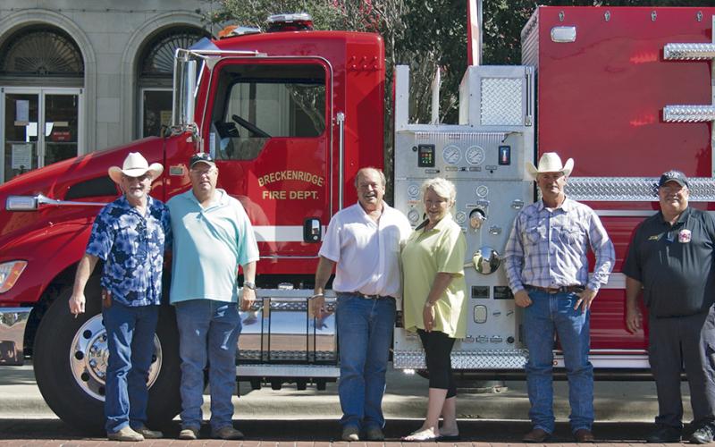 From left, Stephens County Commissioners Rick Carr, Ed Russell, Judge Gary Fuller, Darlene Taylor with Deep South Fire Trucks Commissioner Will Warren and Breckenridge Fire Department Chief Calvin Chaney pose for a photo in front BFD’s  new tanker.
